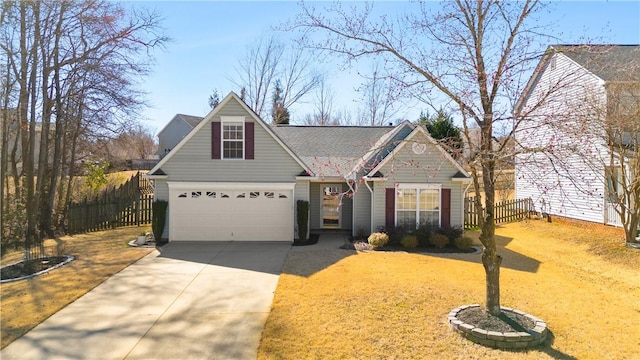 traditional-style house with a garage, concrete driveway, and fence