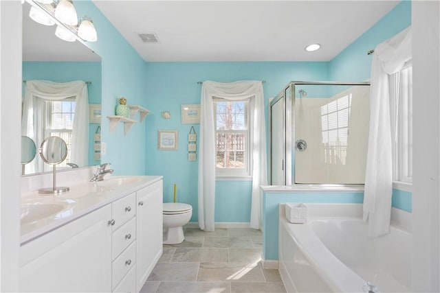 full bath with a healthy amount of sunlight, visible vents, and a sink