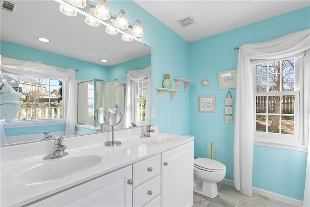 bathroom with a healthy amount of sunlight, visible vents, and a sink