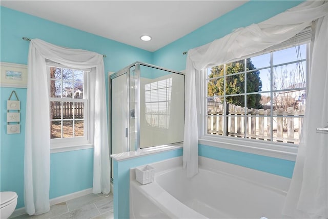 full bathroom featuring toilet, a garden tub, baseboards, and a stall shower