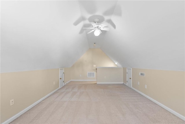 additional living space featuring visible vents, vaulted ceiling, and baseboards