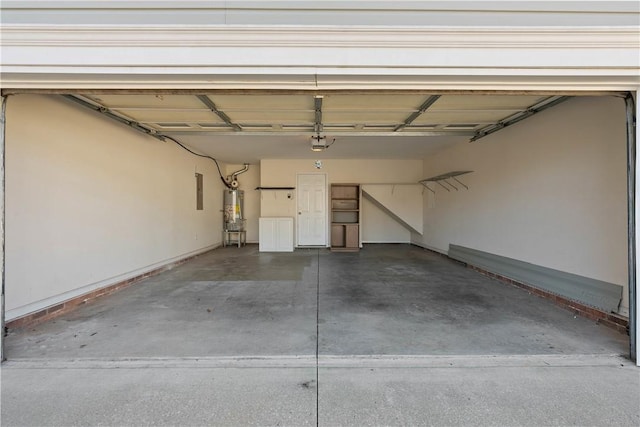 garage featuring water heater and a garage door opener