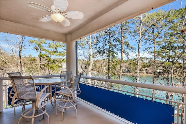 sunroom with a water view and ceiling fan