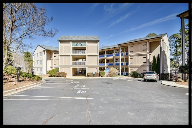 view of property with uncovered parking