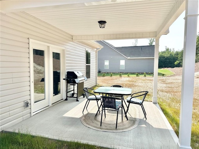 view of patio with outdoor dining area and a grill