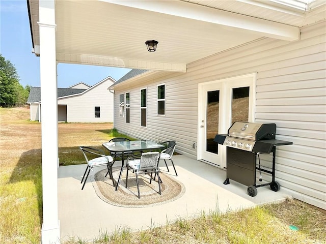 view of patio featuring outdoor dining area and a grill