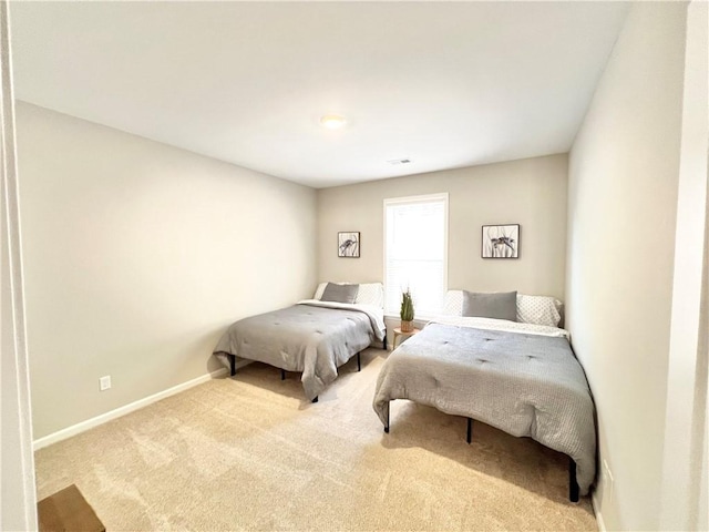 carpeted bedroom featuring visible vents and baseboards