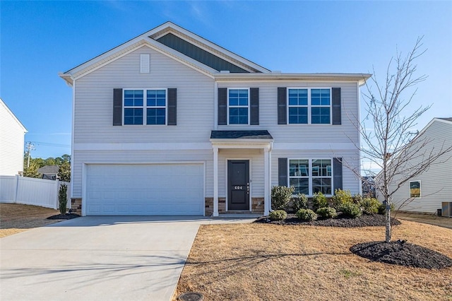 view of front of property featuring an attached garage, fence, central air condition unit, stone siding, and driveway