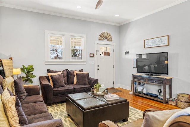 living area featuring ornamental molding, recessed lighting, light wood-style floors, and baseboards