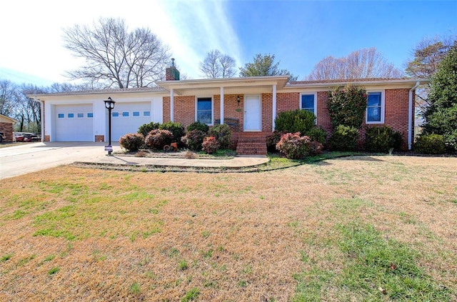 ranch-style home with a chimney, brick siding, a front lawn, and an attached garage