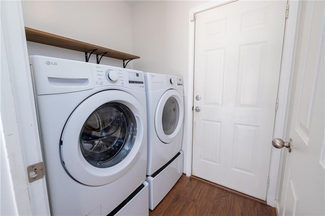 laundry area with laundry area, dark wood-type flooring, and washer and dryer