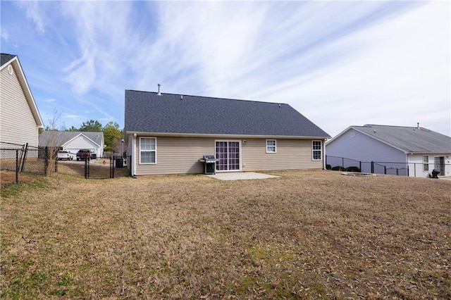 rear view of house featuring a gate, a patio area, a lawn, and fence