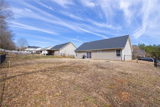 rear view of property featuring fence