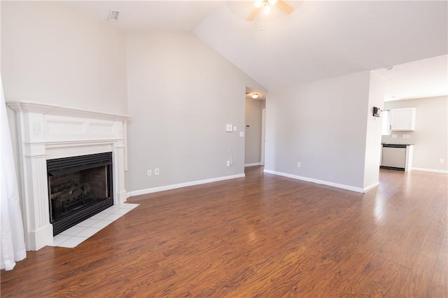 unfurnished living room featuring lofted ceiling, ceiling fan, a fireplace, and wood finished floors