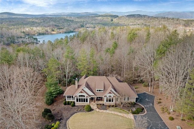 bird's eye view featuring a forest view and a water and mountain view