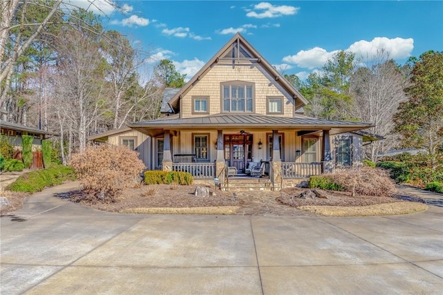 view of front of house with a standing seam roof, metal roof, covered porch, and board and batten siding