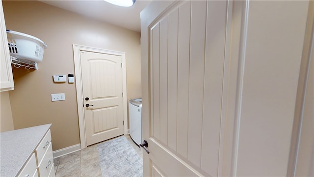 doorway to outside featuring baseboards