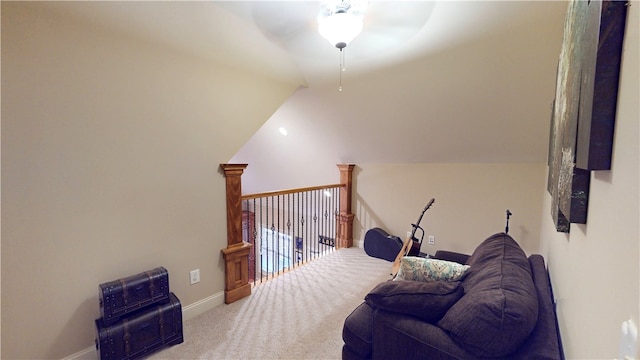 living area featuring lofted ceiling, carpet, a ceiling fan, and baseboards