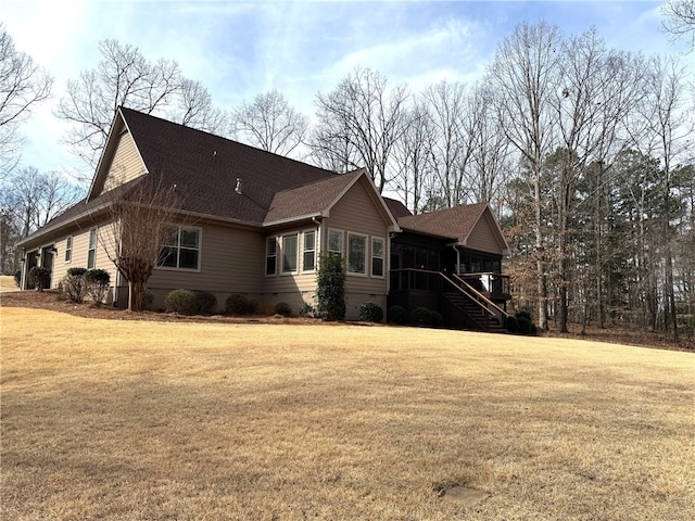 view of side of property with a yard and stairs