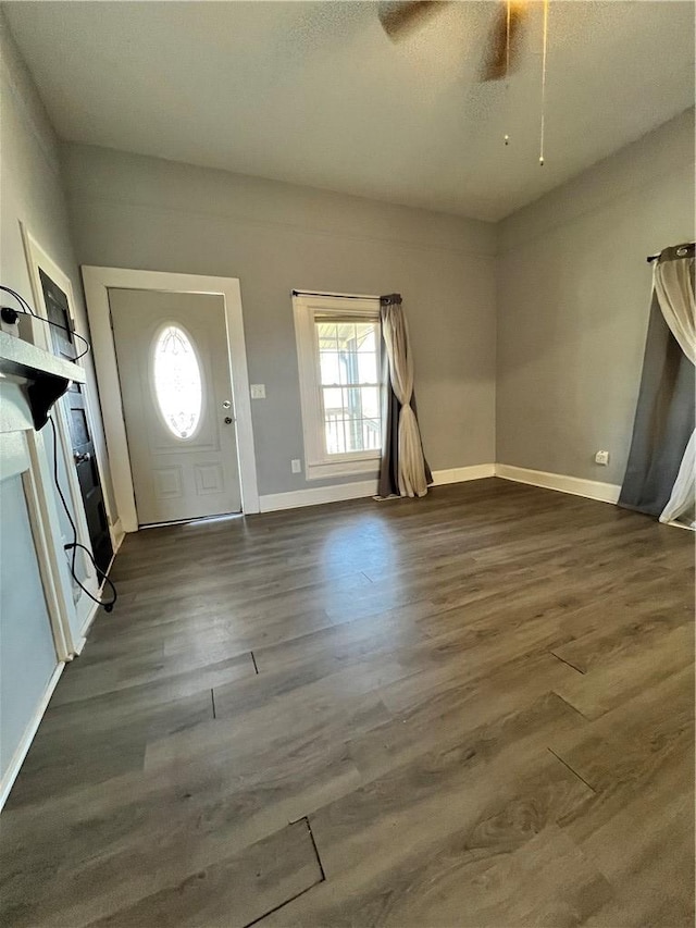 foyer entrance featuring baseboards and wood finished floors