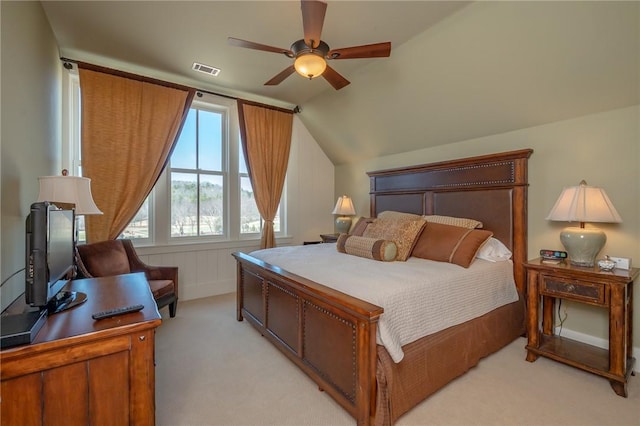 bedroom with light carpet, vaulted ceiling, visible vents, and a ceiling fan