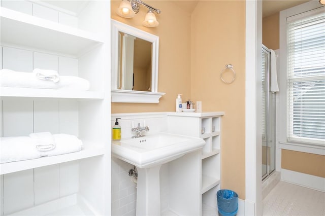 bathroom featuring a sink and a shower stall