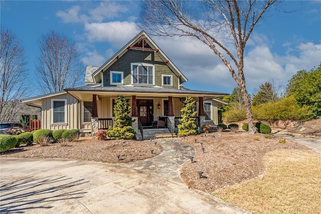 view of front of house featuring a standing seam roof, metal roof, a porch, and board and batten siding