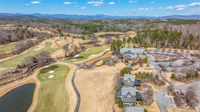 bird's eye view featuring view of golf course, a forest view, and a mountain view