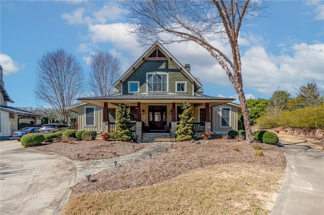 view of front facade featuring a porch, a standing seam roof, metal roof, and board and batten siding