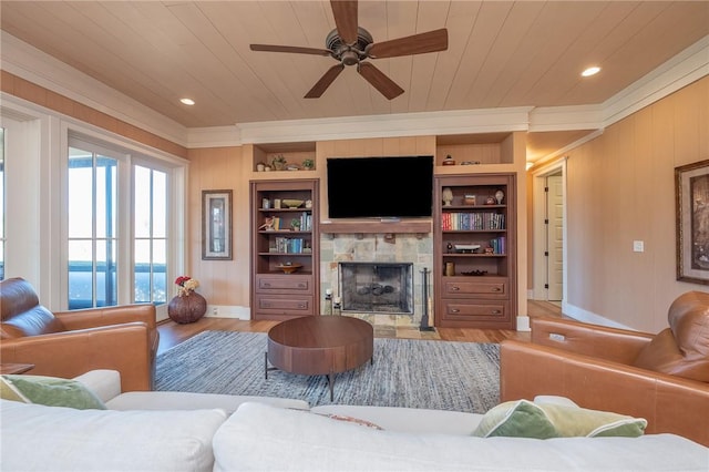 living area with wood ceiling, built in shelves, and wood finished floors