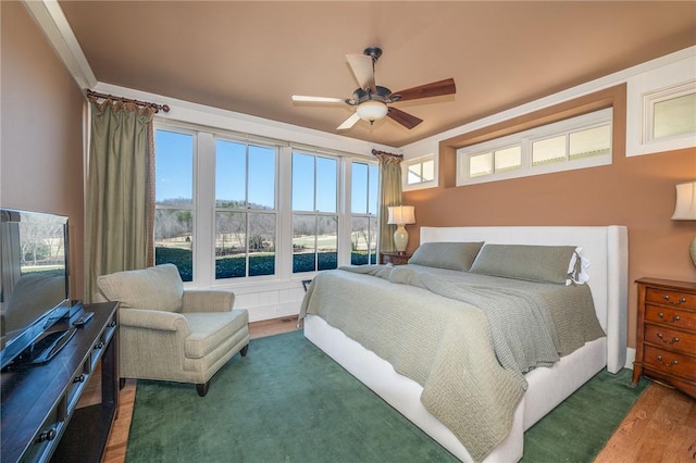 bedroom featuring a ceiling fan and wood finished floors