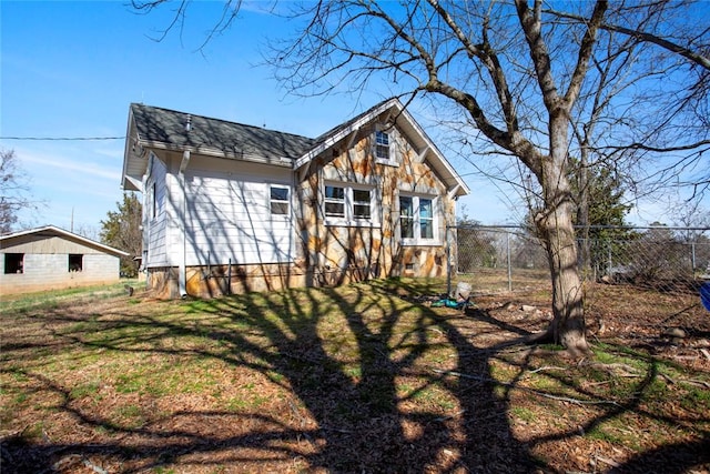 exterior space featuring a lawn and fence