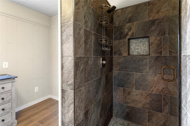 full bathroom with a shower stall, baseboards, wood finished floors, and vanity