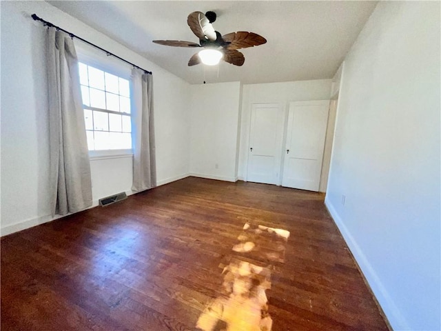 unfurnished bedroom with visible vents, ceiling fan, baseboards, and wood finished floors