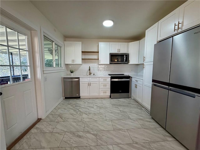 kitchen featuring marble finish floor, open shelves, backsplash, appliances with stainless steel finishes, and white cabinetry