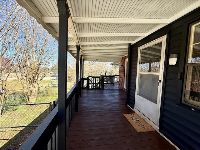 wooden terrace with covered porch and fence