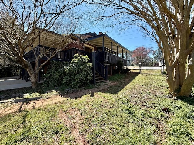 view of home's exterior with stairs, a yard, and fence