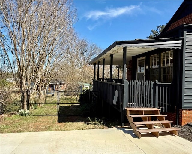 view of side of property with a porch, a gate, and fence