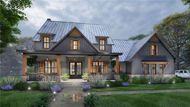 back of house with covered porch, french doors, metal roof, a lawn, and a standing seam roof