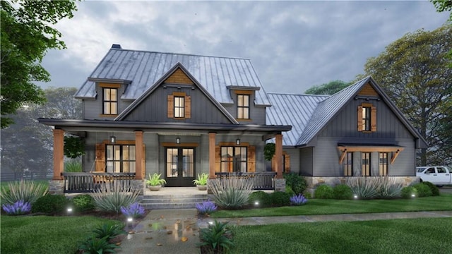 rear view of house featuring covered porch, a standing seam roof, french doors, board and batten siding, and a yard