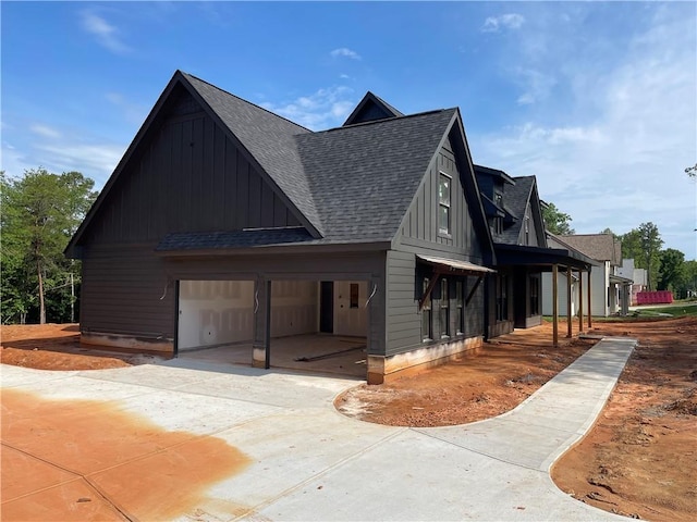 248 W Old Pendleton Rd, Central, SC 29630 - view of home's exterior featuring board and batten siding, a shingled roof, and a garage