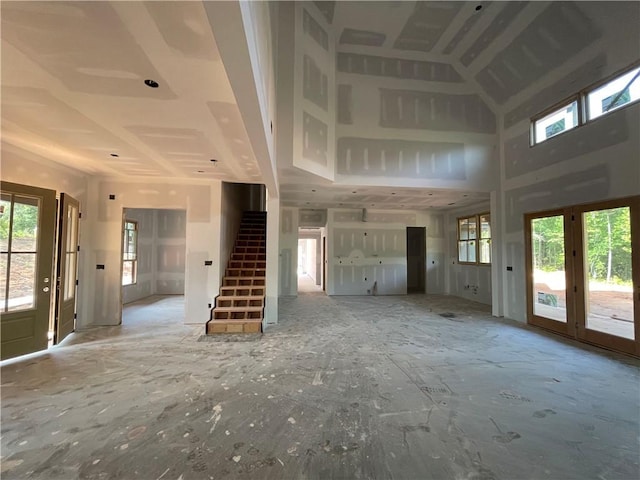 248 W Old Pendleton Rd, Central, SC 29630 - unfurnished living room with plenty of natural light, stairway, french doors, and a towering ceiling