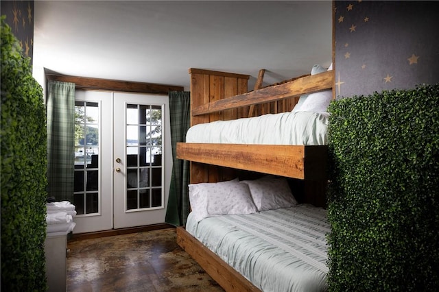 bedroom featuring access to outside, french doors, and finished concrete floors