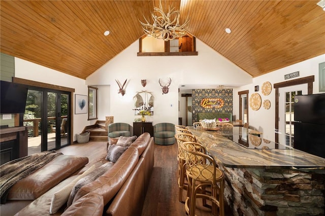 interior space featuring high vaulted ceiling, french doors, wooden ceiling, and wood finished floors