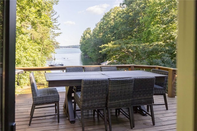 wooden terrace with outdoor dining space and a water view