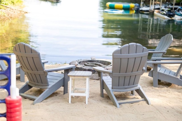 view of patio / terrace with an outdoor fire pit and a water view