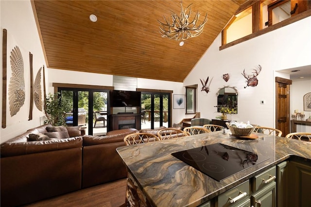 kitchen with wood ceiling, open floor plan, black electric stovetop, french doors, and high vaulted ceiling