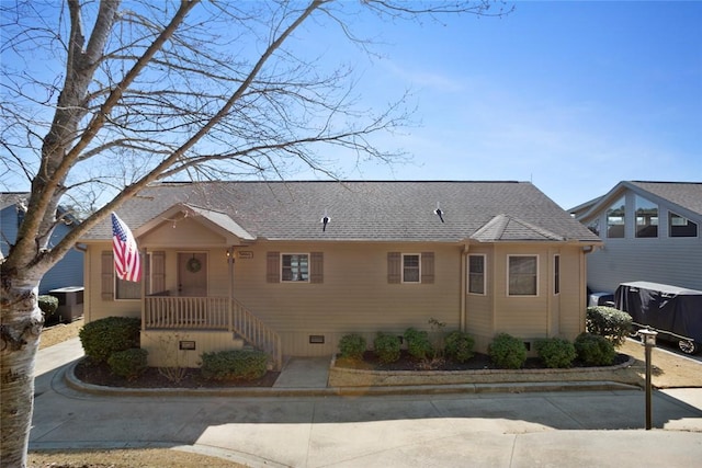 view of front of house with a shingled roof and crawl space