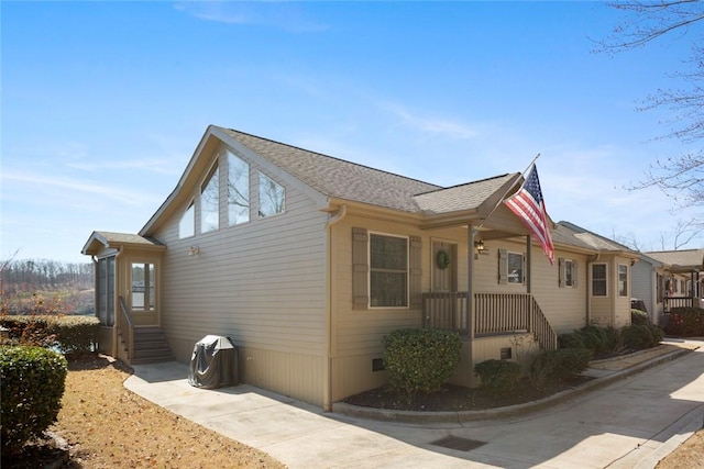 view of home's exterior featuring roof with shingles and crawl space