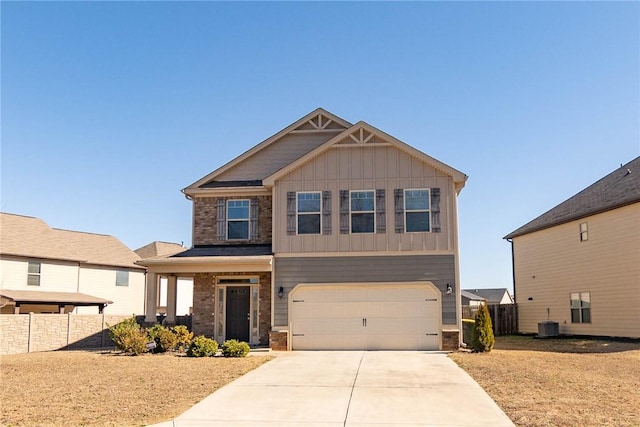 craftsman house with a garage, concrete driveway, fence, central air condition unit, and board and batten siding